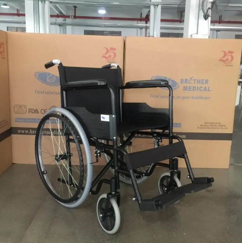 Economy steel wheelchair with fixed armrests and solid rear wheels