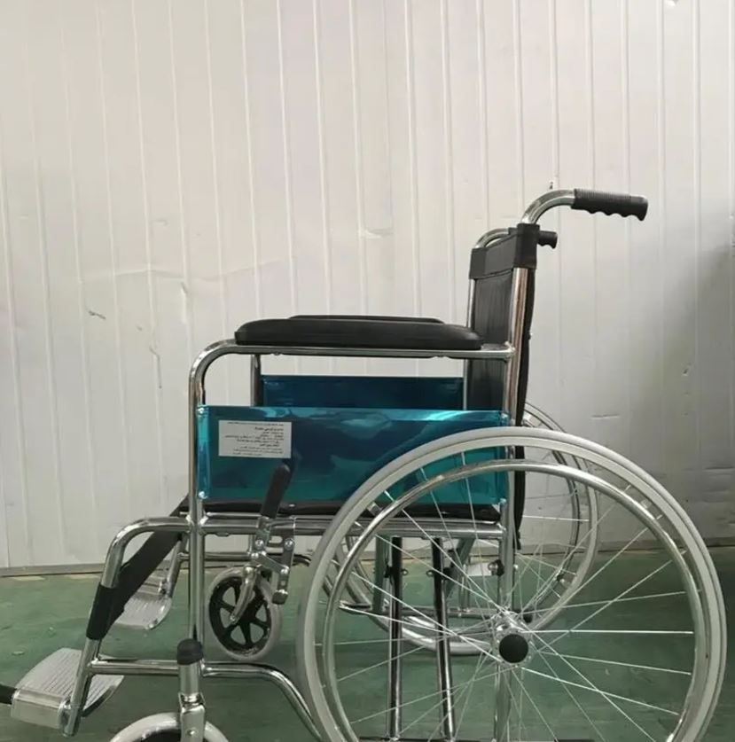 Chrome-plated wheelchair with solid rear wheels and fixed armrests