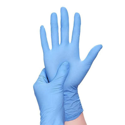 Hand wearing a disposable nitrile glove for hygiene and protection